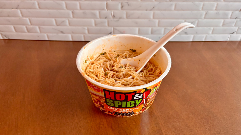 Bowl of hot and spicy chicken ramen with spoon