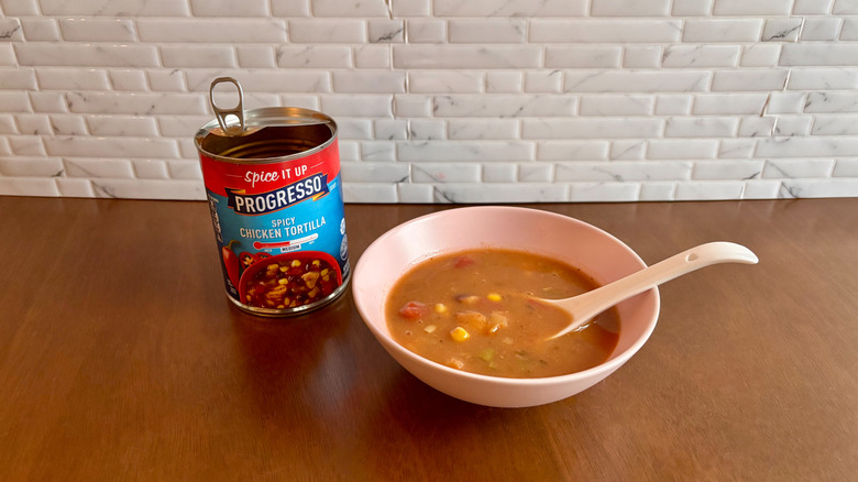 Can of Progresso soup next to bowl of soup