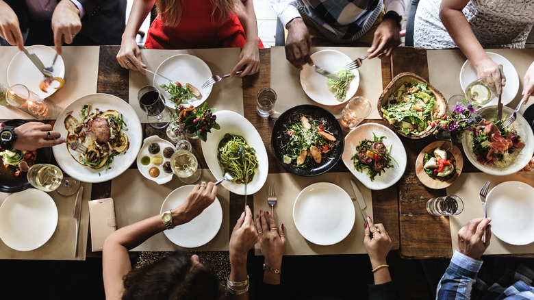 table filled with people and food