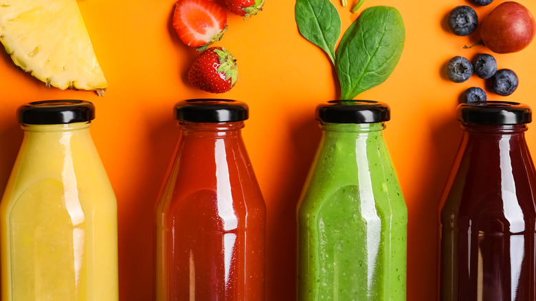 glass bottles of juice and fruit