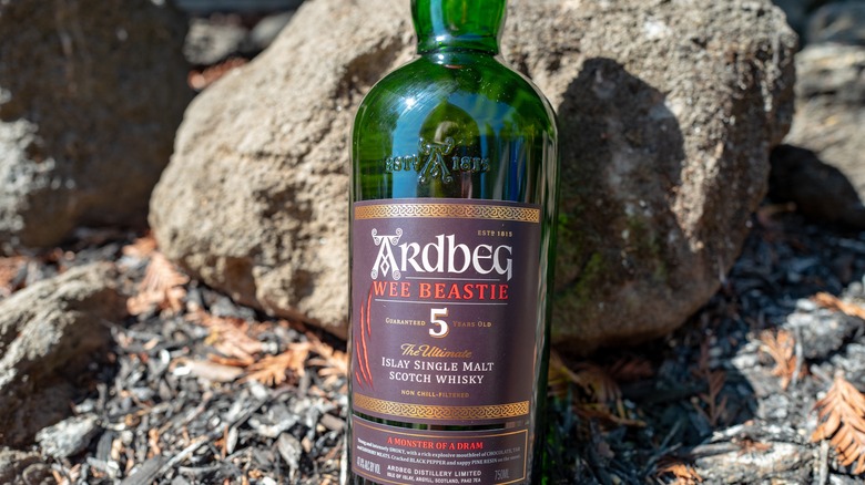 bottle of Ardbeg Scotch against rocks