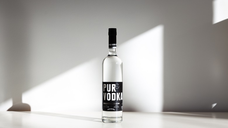 bottle of Pur Vodka on grey background