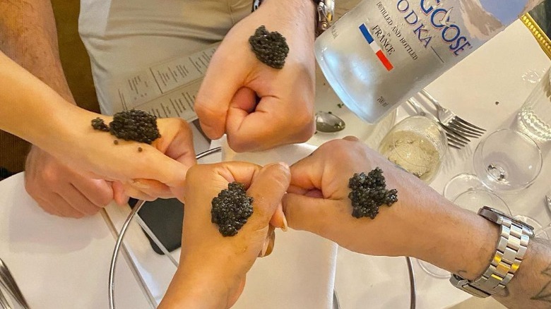 Caviar on people's hands