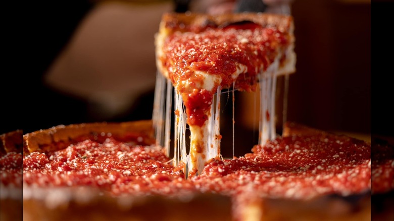 Cheesy slice being pulled out of a deep dish pizza from Bourbon House