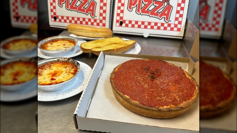 Deep dish pizza, garlic bread, and piza boxes from Tony's Little Italy