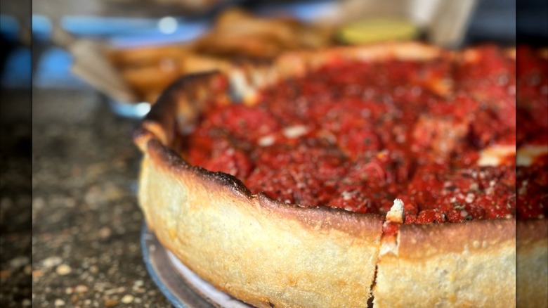 Deep dish pizza from Vero's sitting on a table blurred background