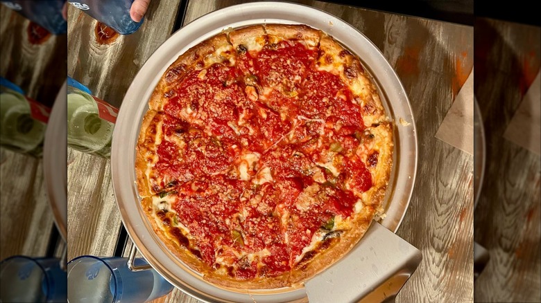 Wilsons deep dish pizza on a wooden table