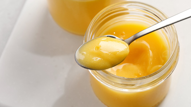 lemon curd on spoon and jar