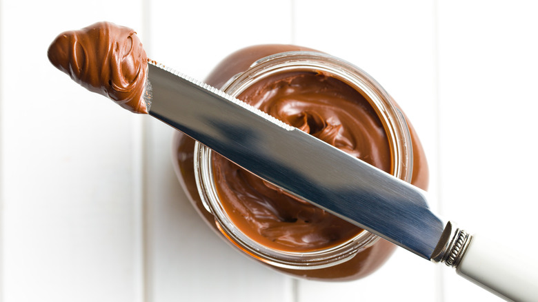 Nutella on knife and jar