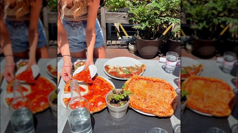 Woman takes pizza slice outside