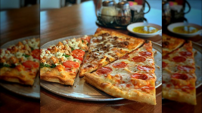 Assorted pizza slices, metal pan