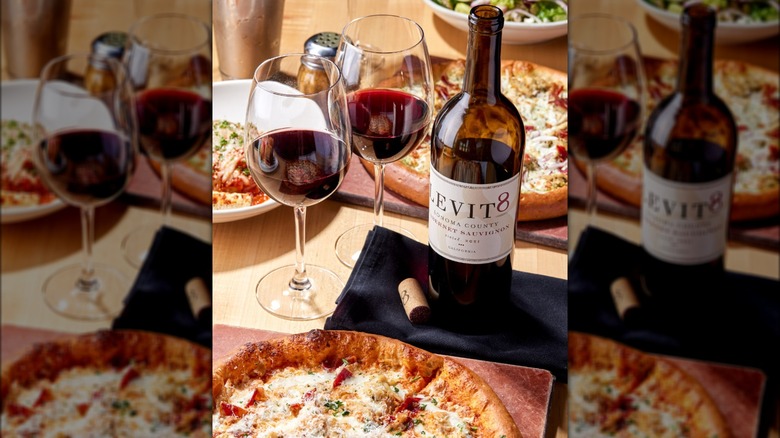 Pizza, wine glasses, bottle