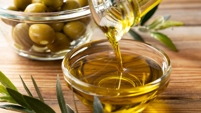 Pouring olive oil into bowl