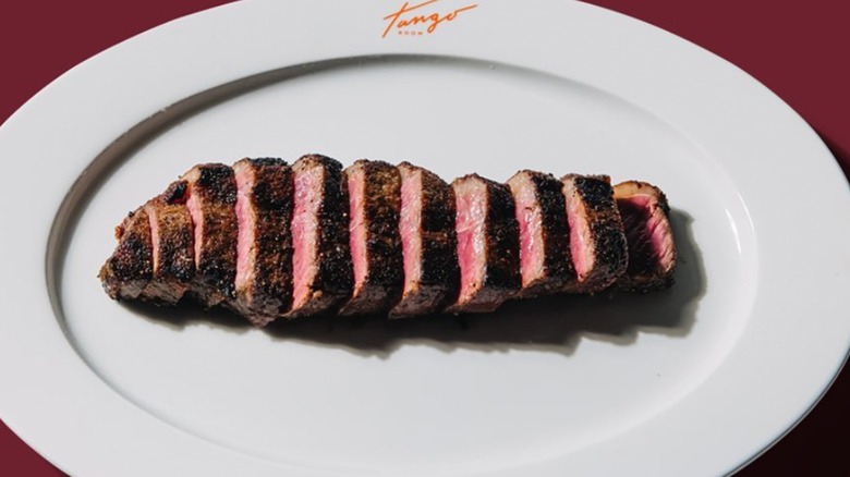 Tango Room sliced steak on white platter