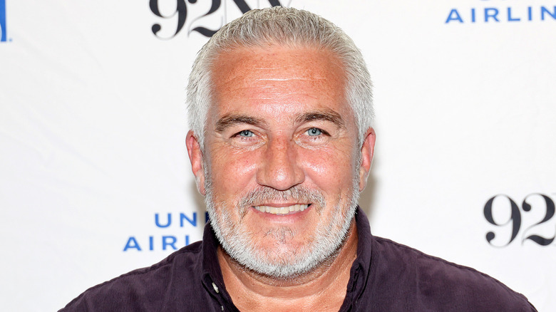 Celebrity chef Paul Hollywood smiling in brown shirt