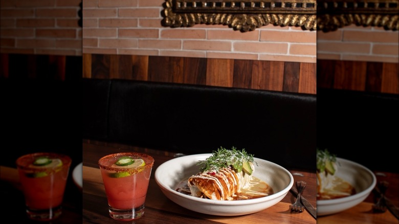 Enchiladas on table with drink