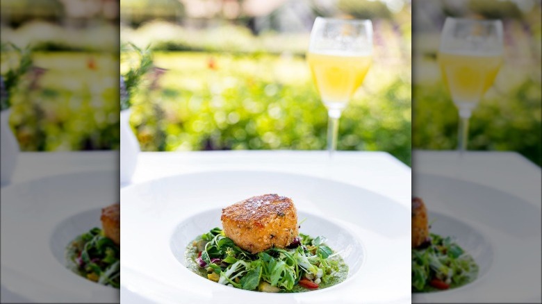 Crab cake on bed of arugula