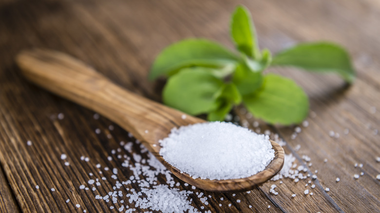 Stevia granules on wooden spoon