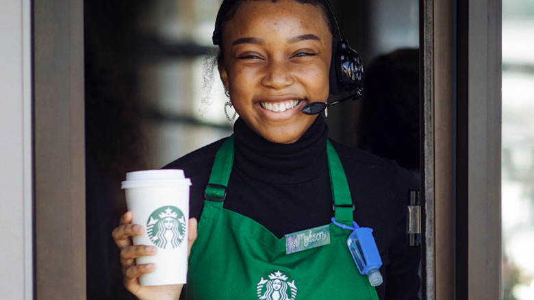 barista holding cup of coffee