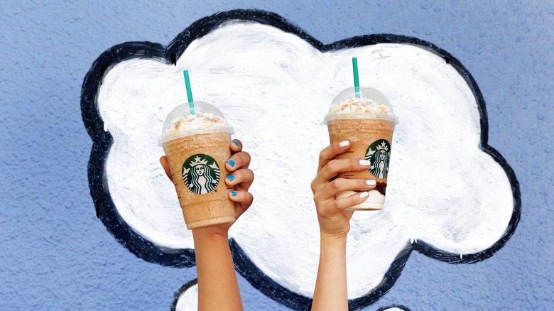Hands holding two Frappuccinos