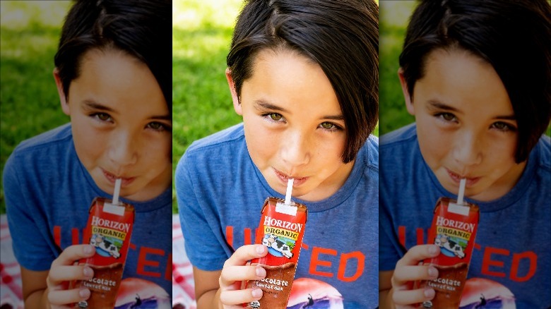 Child drinking from milk box