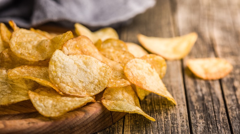 Potato chips on wood board