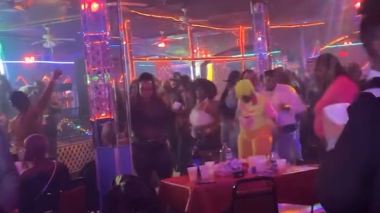 people dancing in colorful club