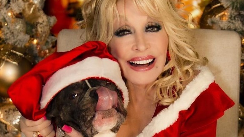 Dolly Parton smiling with dog 