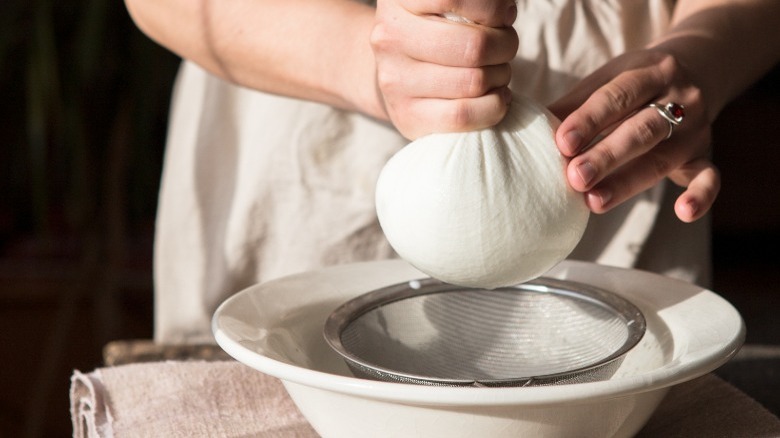 Straining cheese with a strainer