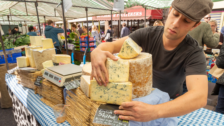 cheese stall man busy market