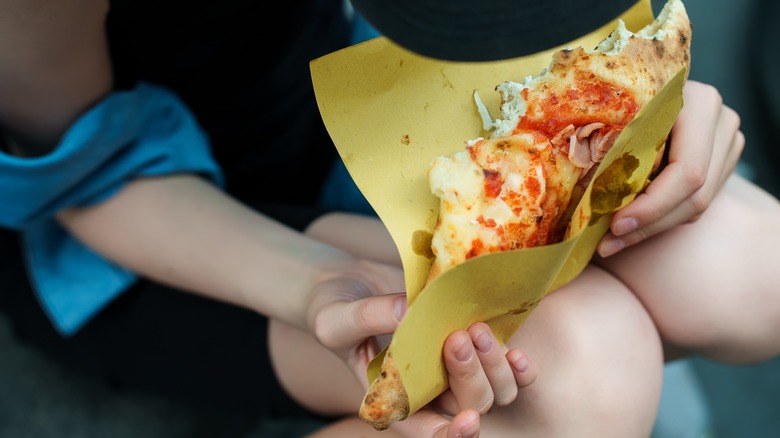 Person holding calzone