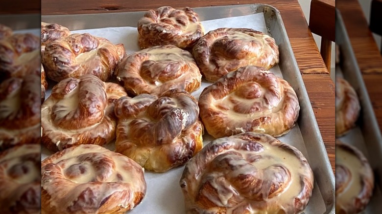 A tray of glazed cinnamon rolls