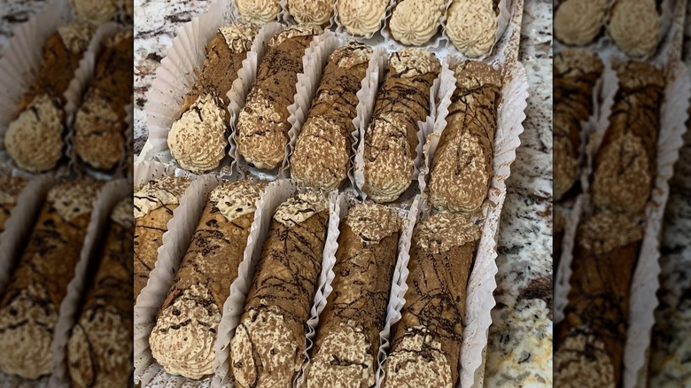 Rows of cannolis filled with cream