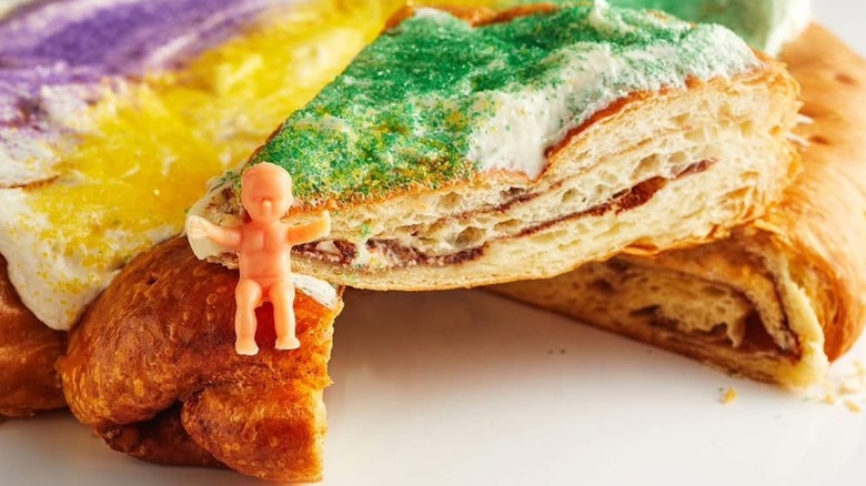 A slice of king cake with a small plastic baby