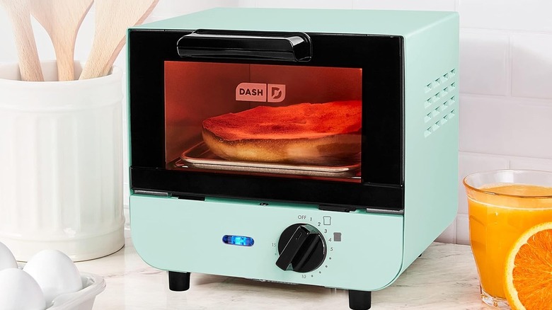 Dash mini toaster oven with half a bagel inside