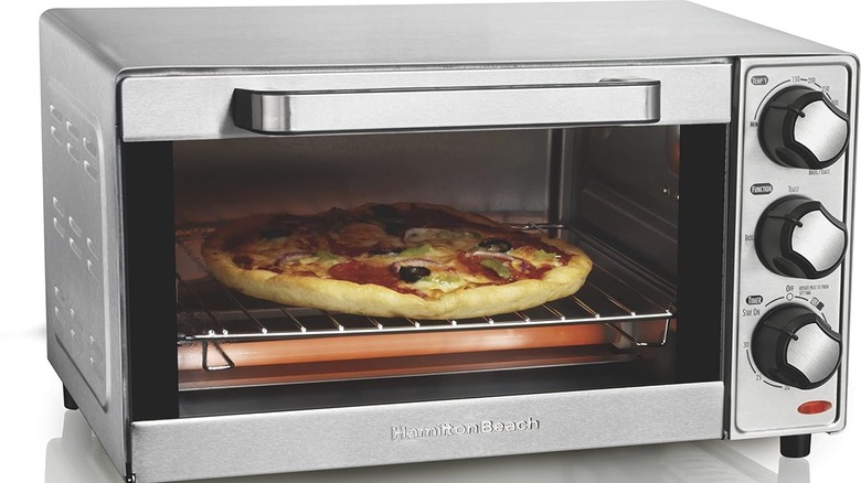 Hamilton Beach countertop toaster oven and pizza maker with pizza inside