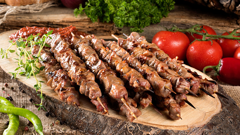 pile of lamb kebabs on cutting board