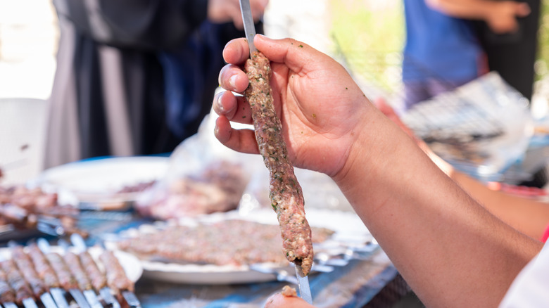 Hand forming lamb kebabs