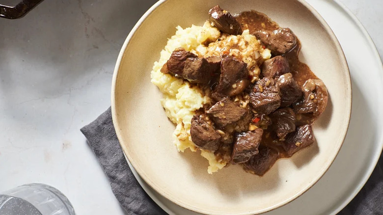 Saucy steak tips over mashed potatoes