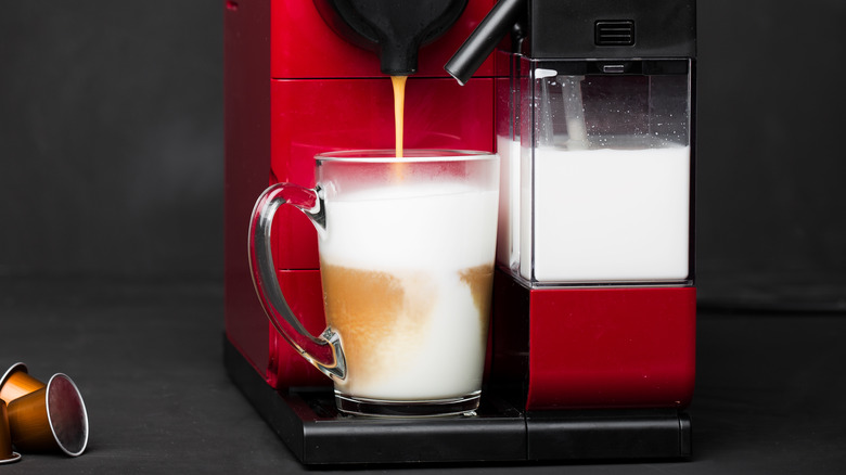 nespresso machine, glass cup with milk