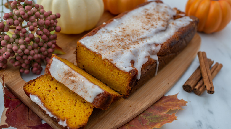 punpkin bread with glaze on wood board