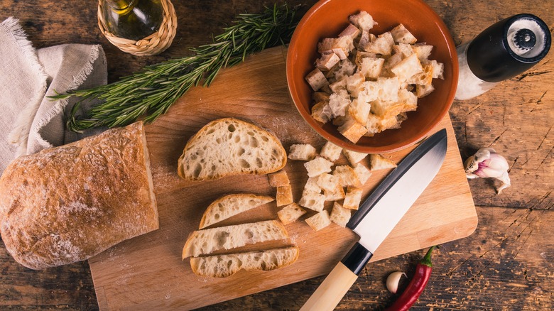 Ciabatta bread and ingredients on cutting board