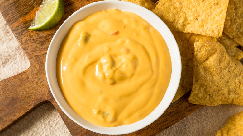 queso dip in bowl with chips