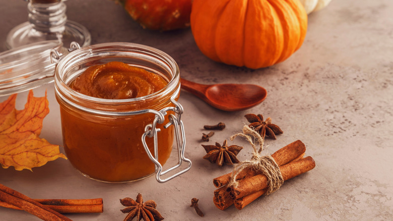 Jar of pumpkin butter with pumpkins