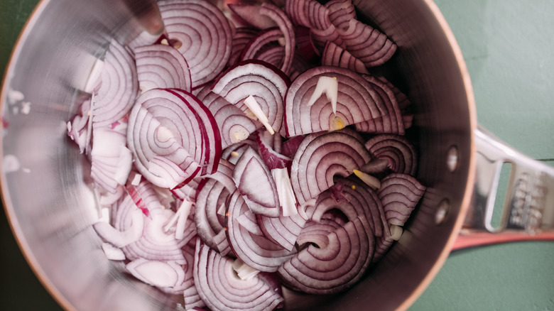 diced red onion sautéing in pan 