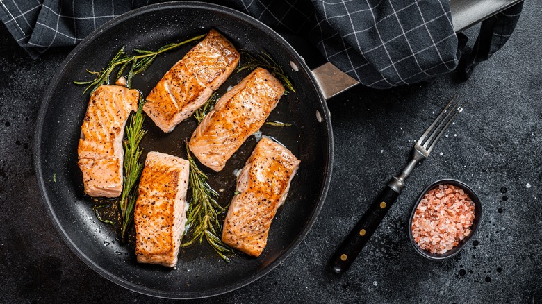 Salmon cooking in pan 