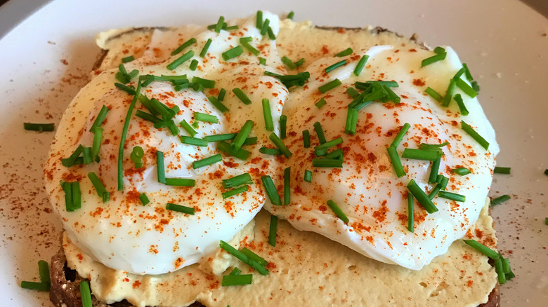 poached eggs over hummus on toast