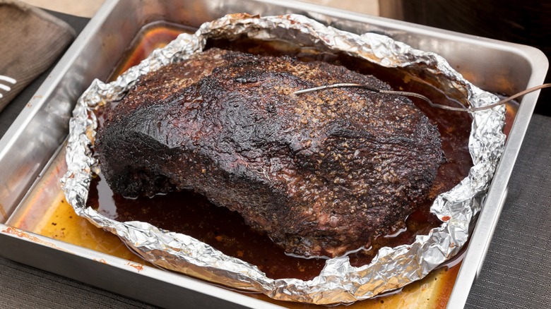 Brisket wrapped in foil in roasting pan