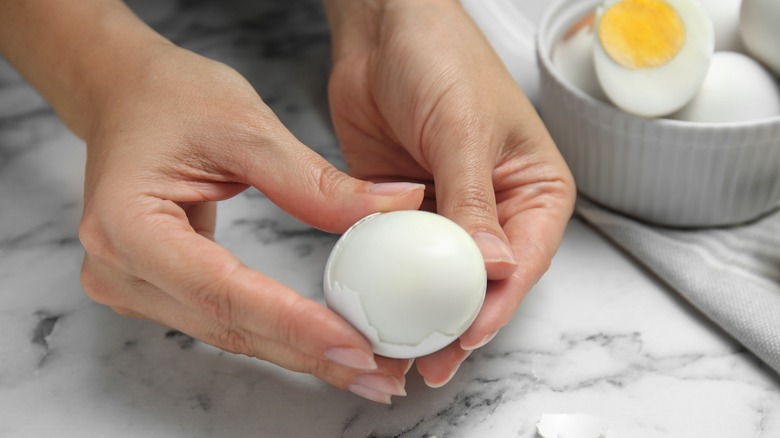 Hand peeling egg