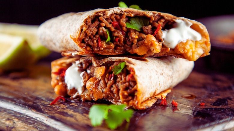 two stacked burritos on a table